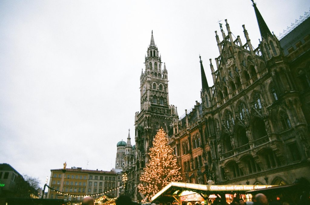 A stunning view of Munich's Marienplatz with a Christmas tree and historic architecture creating a festive atmosphere.